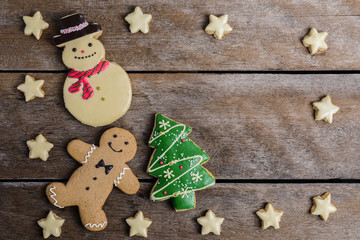 Festive Christmas Cookie and New Year in the shape of Christmas tree, Gingerbread man, snowman, Snowflake, star on wooden table