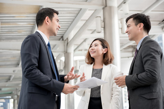 Happy Asian Business Associate Meeting Outside The Office  Discussing Work