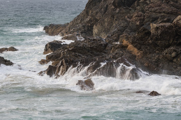 waves crashing on the rocks of the headland