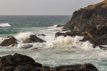 waves crashing on the rocks of a headland