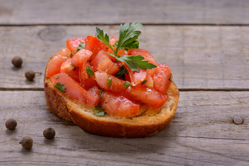 Tasty Italian appetizers, bruschetta with tomato and parsley