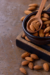 Almonds nuts on wooden spoon