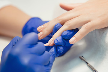 Fototapeta premium Manicure. Master does manicure on nails paint hand
