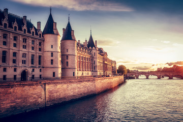 Beautiful skyline of Paris, France, with Conciergerie, Pont Neuf at sunset. Colourful travel background. Romantic cityscape.