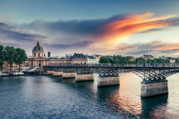Obraz premium Famous Pont Neuf in Paris, France. Spectacular cityscape with dramatic sunset sky.