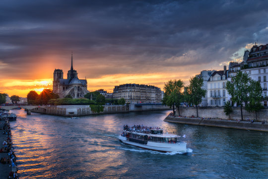 Fototapeta Notre Dame cathedral in Paris, France against sunset sky. Scenic skyline. Colourful travel background.