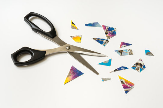 Scissors and pieces of credit card isolated on white