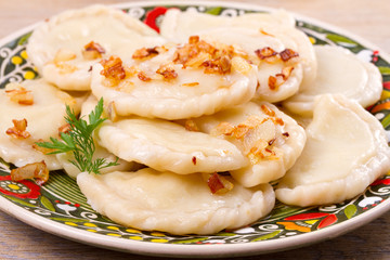 Dumplings, filled with potato and served with salty caramelized onion. Varenyky, vareniki, pierogi, pyrohy - popular dish in East Europe, horizontal