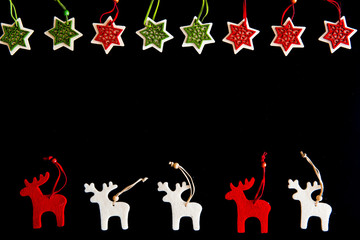 Felt rein deers and snowflakes isolated on black