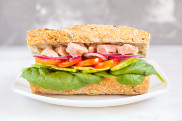 Healthy tuna sandwich with vegetables and rye baguette