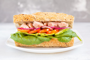 Healthy tuna sandwich with vegetables and rye baguette