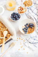 Baked oats granola with nuts and honey, milk and homemade yogurt.