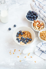 Baked oats granola with nuts and honey, milk and homemade yogurt.