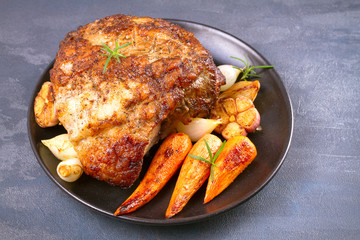 Roasted ham with vegetables on grey rustic background, horizontal