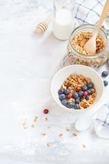 Baked oats granola with nuts and honey, milk and homemade yogurt.