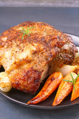 Roasted ham with vegetables on grey rustic background, vertical