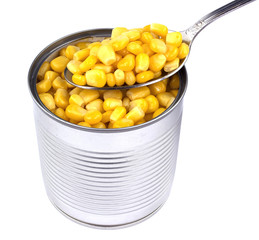 Pile of a canned corn and a spoon over it, composition isolated