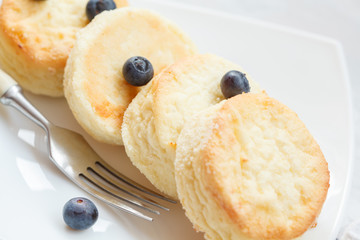 Homemade cottage cheese pancakes with sour cream with berries and sour cream.