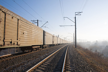Naklejka na ściany i meble Railway bend with freight train.