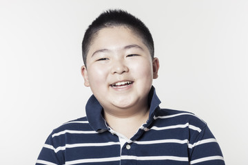 A fat boy portrait with smile isolated white.