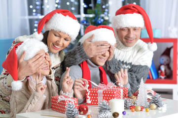 young parents and children with Christmas gifts