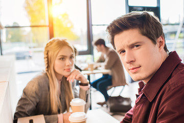 Man sitting with girl in cafe
