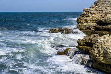 waves break against rocks