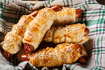 Rolled hot dog sausages baked in puff pastry