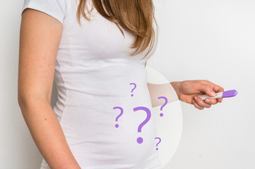 Woman with imagination of a pregnant belly - infertility concept