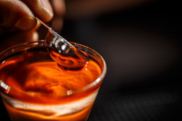 Barman hand pouring alcohol