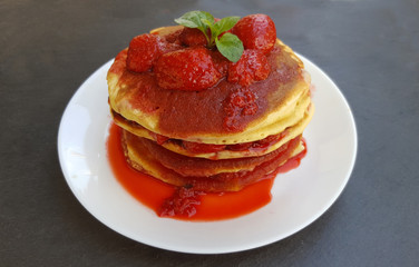 Delicious pancakes  with strawberries and syrup