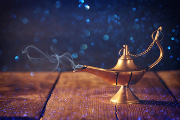 Image of magical aladdin lamp with glitter smoke. Lamp of wishes.