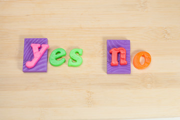 Yes or NO word dilemma on wooden background