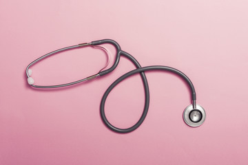 Fototapeta premium stethoscope on the pink color paper background.