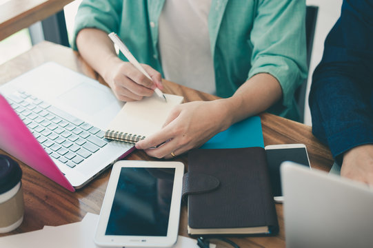 Asian man writing text on notebook