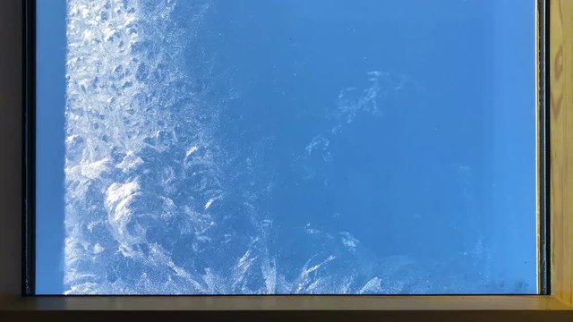 Timelapse of window defrosting and freezing back