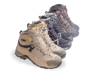 Three pairs boots for trekking on a white background