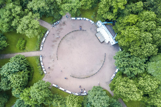 Round platform with a stage and benches in the park, top view