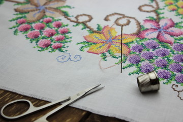 Hand embroidery with needle and scissors