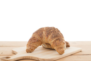 Croissant bread on wooden table.
