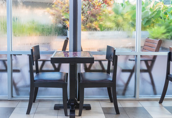 Table and chairs are located by the window.