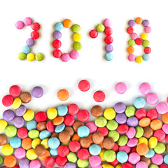 Fototapeta na wymiar 2018 colorful candies isolated on white background