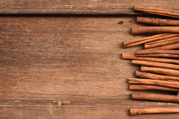 Cinnamon sticks on wooden background