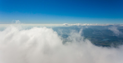 Naklejka na ściany i meble Aerial flying above clouds.