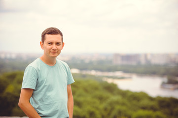 Fototapeta premium man looks at the city from a height. warm day
