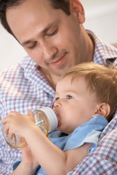 Father feeding baby from bottle