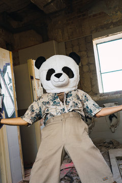 Man with plush panda head
