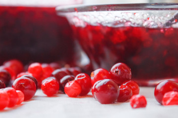 Berries, berries jam in a bowl and a jar of close-up jam