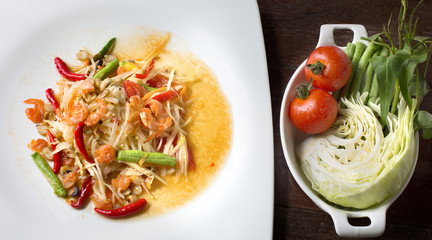 papaya salad and vegetable on wooden plate, Thai food
