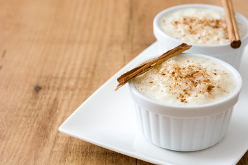Arroz con leche. Rice pudding with cinnamon on wooden background.Copyspace
